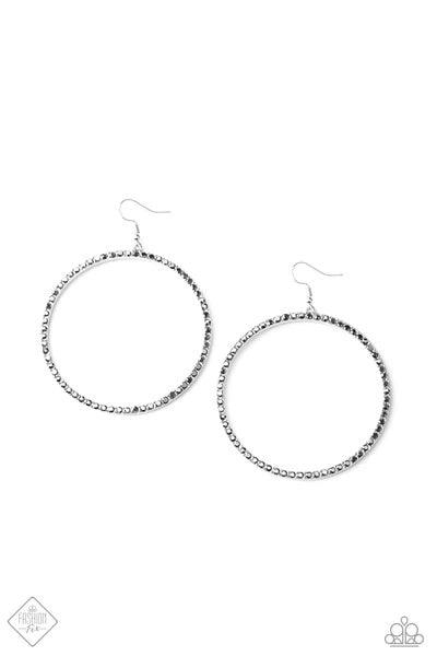 Paparazzi Accessories Wide Curves Ahead - Silver Encrusted in smoky hematite rhinestones, a dramatically oversized hoop swings from the ear for an exaggerated effect. Earring attaches to a standard fishhook fitting. Hoop measures approximately 2 1/4" in d