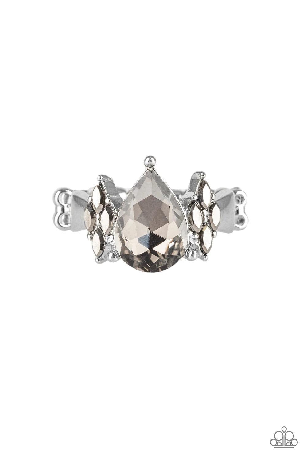 Paparazzi Accessories Yas Queen - Silver A dramatic golden teardrop gem is pressed into the center of a dainty gold band. Featuring regal marquise-cuts, dainty golden rhinestones flank the sparkling teardrop center for a glamorous finish. Features a daint