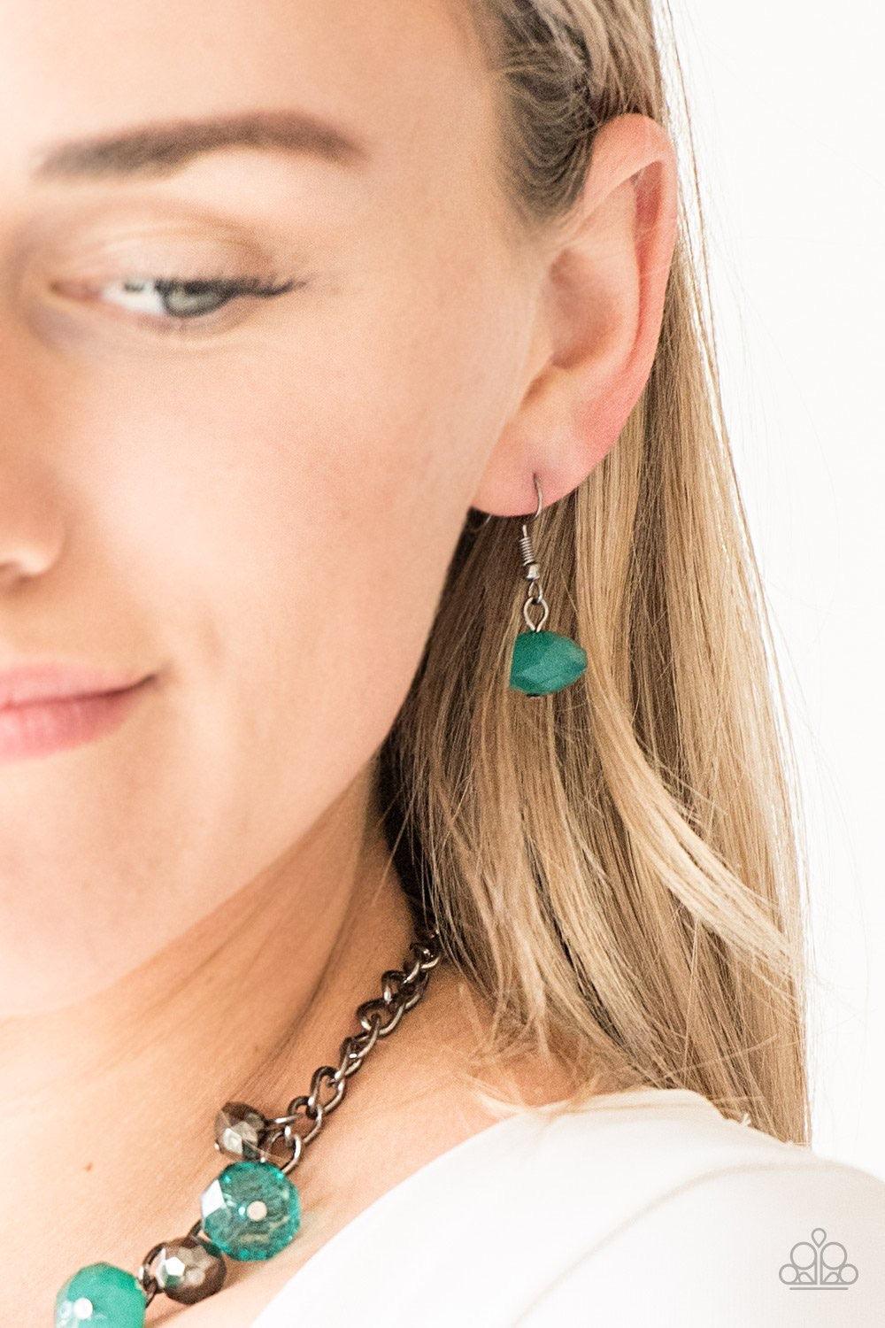 Paparazzi Accessories Runway Rebel - Green Featuring cloudy and glassy finishes, faceted green crystal-like beads swing from the bottom a glistening gunmetal chain. Faceted gunmetal beads join the fiery beading, creating a flirtatious fringe below the col