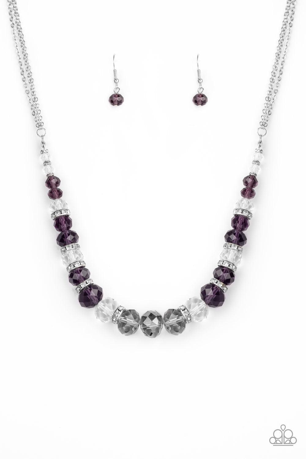 Paparazzi Accessories Distracted by Dazzle - Purple Attached to strands of shimmery silver chains, a glittery collection of purple, smoky, and white crystal-like gems and white rhinestone encrusted silver rings are threaded along an invisible wire below t