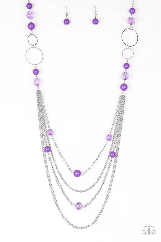 Paparazzi Accessories Collectively Carefree - Purple Infused with two plain strands of shimmery silver chains, polished purple beads and shimmery silver hoops trickle along a bold silver chain for a whimsically layered look. Features an adjustable clasp c