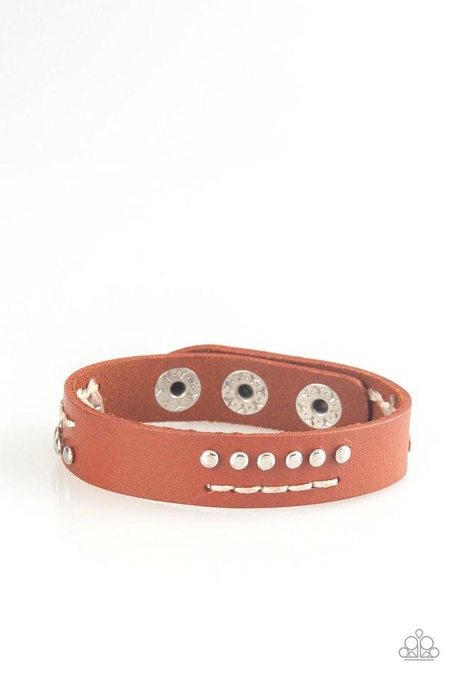 Paparazzi Accessories Always An Adventure - Brown Sections of shimmery silver studs and stitched white thread adorns the front of a brown leather band for an adventurous look. Features an adjustable snap closure. Jewelry