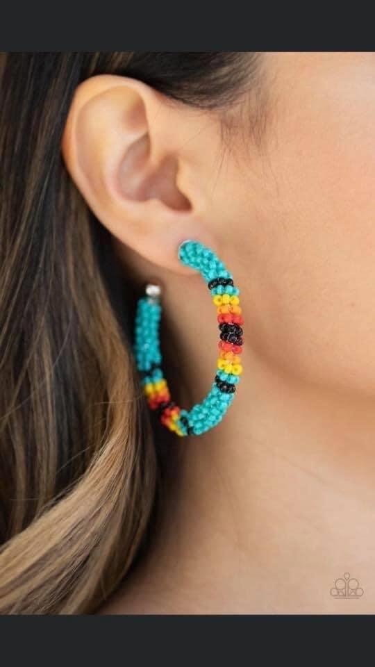 Paparazzi Accessories Bodaciosuly Beaded - Blue A colorful strand of blue, black, yellow, orange, and red seed beads wraps around a shiny silver hoop, creating a colorfully seasonal look. Earring attaches to a standard post fitting. Hoop measures approxim