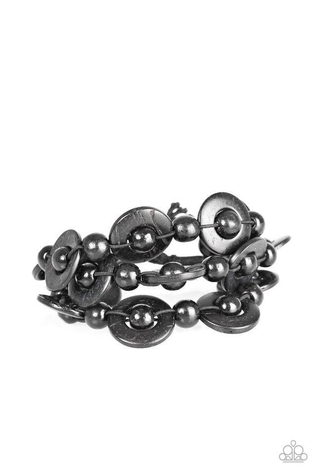 Paparazzi Accessories Cancun Catch ~Black Brushed in distressed black finishes, wooden rings and beads are knotted in place along three stretchy strands, creating summery layers around the wrist. Features a button loop closure. Sold as one individual brac