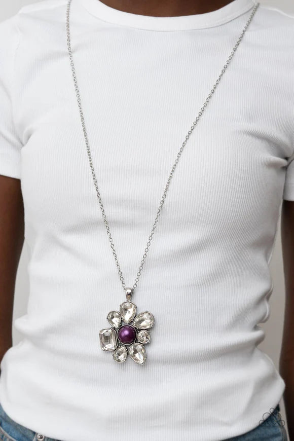Paparazzi Accessories BLOOM Shaka-laka - Purple Encased in pronged silver fittings, a mismatched collection of oversized teardrop, round, and emerald cut rhinestones asymmetrically blooms from a bubbly purple pearl drop center for a surprisingly sparkly f