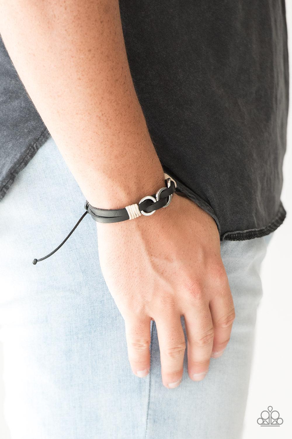 Paparazzi Accessories Off-Road Tourist - Black Infused with white twine cording, antiqued silver rings are threaded along strands of black leather bands for a rustic look. Features an adjustable sliding knot closure. Jewelry Sets