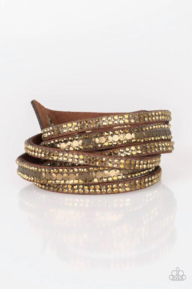 Paparazzi Accessories Rock Star Attitude - Brass Encrusted in rows of glittery aurum rhinestones and flat brass studs, three strands of brown suede wrap around the wrist for a sassy look. The elongated band allows for a trendy double wrap around the wrist