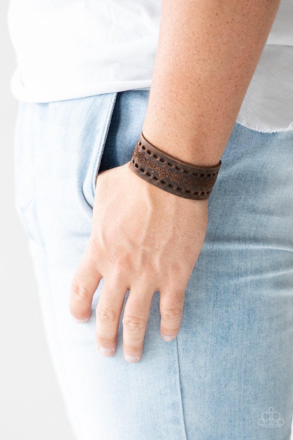 Paparazzi Accessories Make The WEST of It - Brown Stamped in a southwestern textile inspired pattern, a distressed brown leather band wraps around the wrist for a seasonal look. Features an adjustable snap closure. Jewelry
