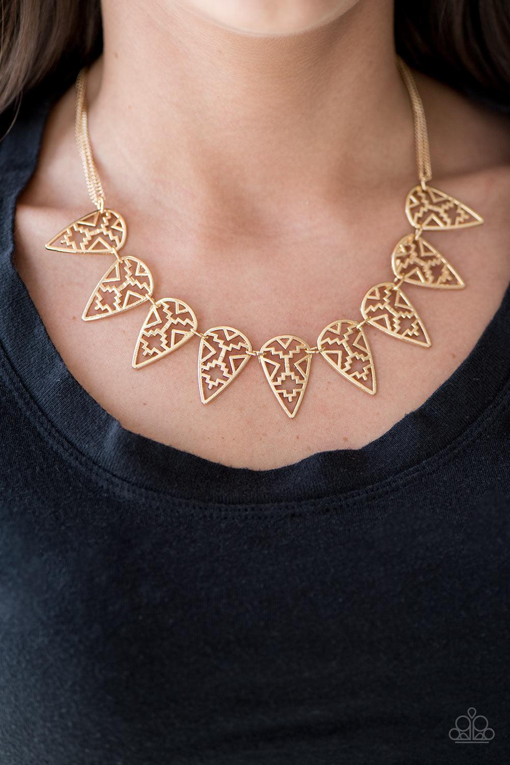 Paparazzi Accessories Triassic Triumph ~Gold Suspended from double-stranded gold chains, airy tribal frames link below the collar in an indigenous inspired fashion. Features an adjustable clasp closure. Sold as one individual necklace. Includes one pair o