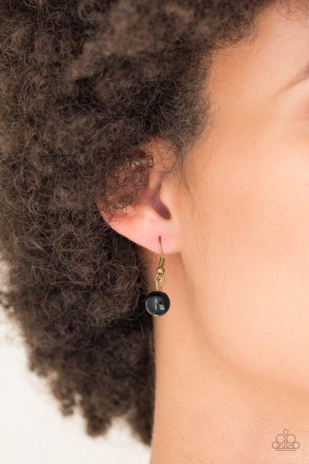 Paparazzi Accessories Hey, SOL Sister - Black Gradually increasing in size near the center, round brass frames radiating with sunburst patterns link below the collar. Infused with shiny brass studs, the tribal inspired frames are dotted with black beaded