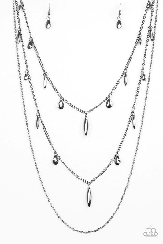 Paparazzi Accessories Bravo Bravado - Black Mismatched gunmetal chains layer down the chest. Faceted gunmetal teardrops and shiny gunmetal accents swing from two of the shimmery gunmetal chains for an edgy finish. Features an adjustable clasp closure. Sol