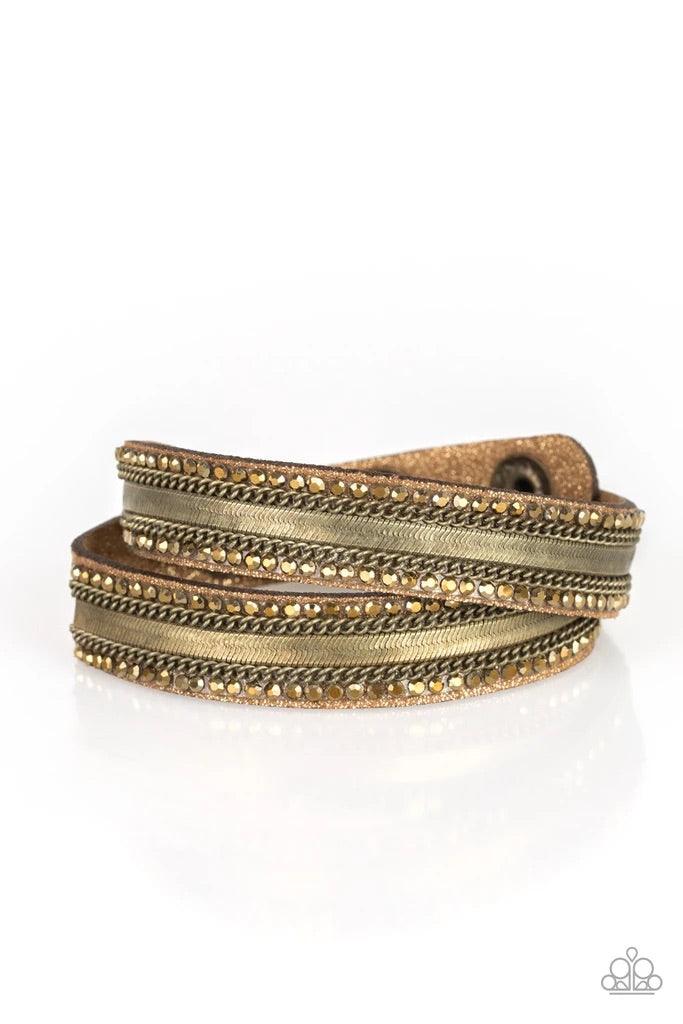 Paparazzi Accessories Rocker Rivalry - Brass Rows of classic brass chain, flat brass chain, and dainty aurum rhinestones are encrusted along a brown suede band dusted in golden sparkles for a sassy look. The elongated band allows for a trendy double wrap