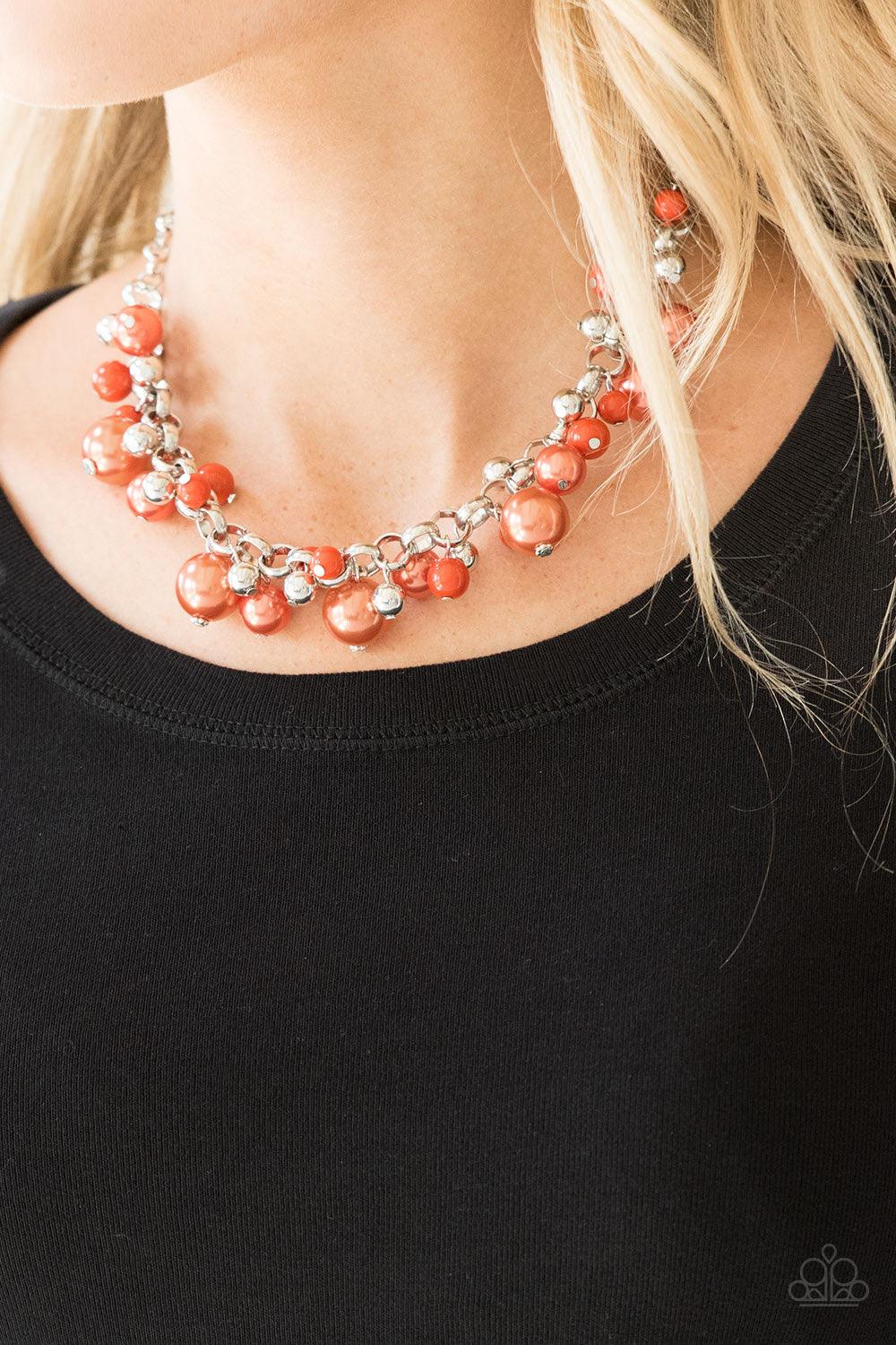 Paparazzi Accessories The Upstater - Orange Varying in size, bubbly orange pearls, classic silver beads, and shiny orange beads swing from the bottom of a glistening silver chain, creating a refined fringe below the collar. Features an adjustable clasp cl