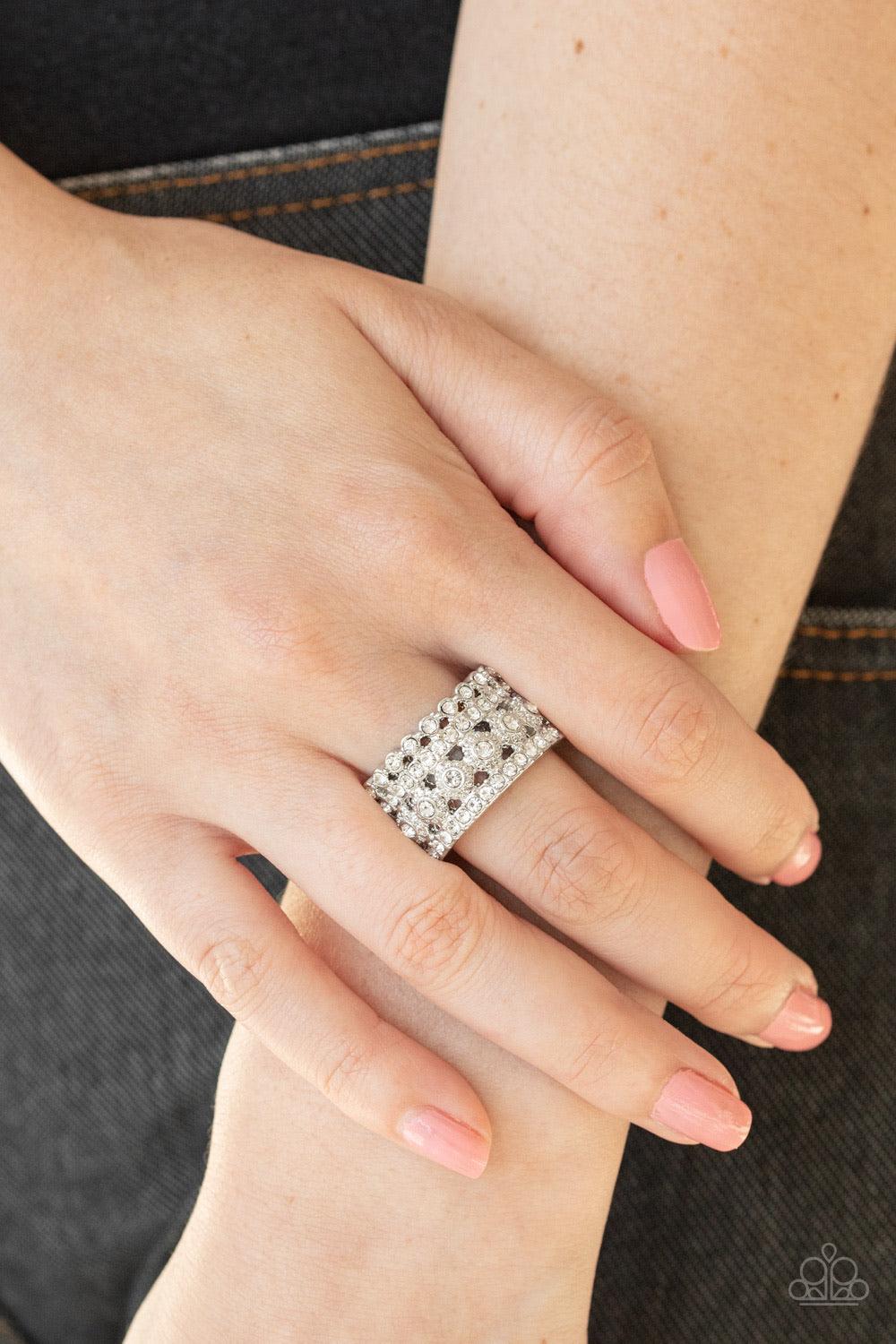 Paparazzi Accessories Countess Couture - White Mismatched bands of glassy white rhinestones layer across the finger, coalescing into a glitzy stacked band. Features a stretchy band for flexible fit. Sold as one individual ring. Jewelry