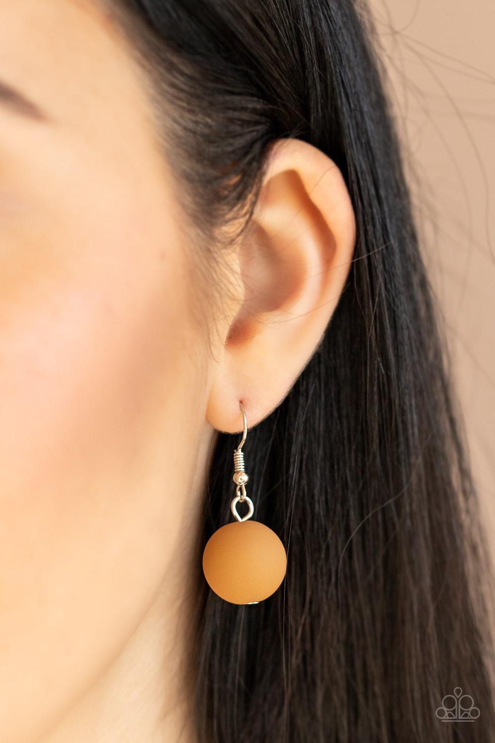 Paparazzi Accessories Pop The Cork - White Featuring white accents, cork-like frames and brown matte beads are threaded along an invisible wire below the collar for a statement-making look. Features an adjustable clasp closure. Sold as one individual neck