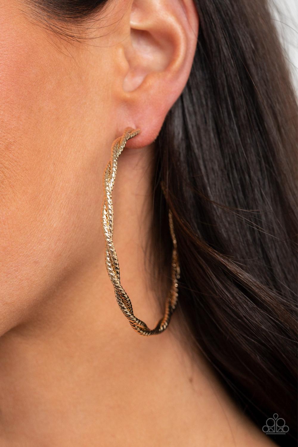 Paparazzi Accessories Totally Throttled - Gold Featuring diamond-cut shimmer, two glistening gold wires delicately twist into an oversized hoop for an edgy look. Earring attaches to a standard post fitting. Hoop measures approximately 2 3/4" in diameter.