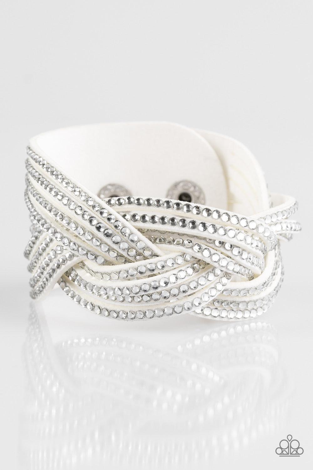 Paparazzi Accessories Big City Shimmer - White Glassy white rhinestones are encrusted along crisscrossing strands of white suede, creating bold shimmer around the wrist. Features an adjustable snap closure. Sold as one individual bracelet. Jewelry