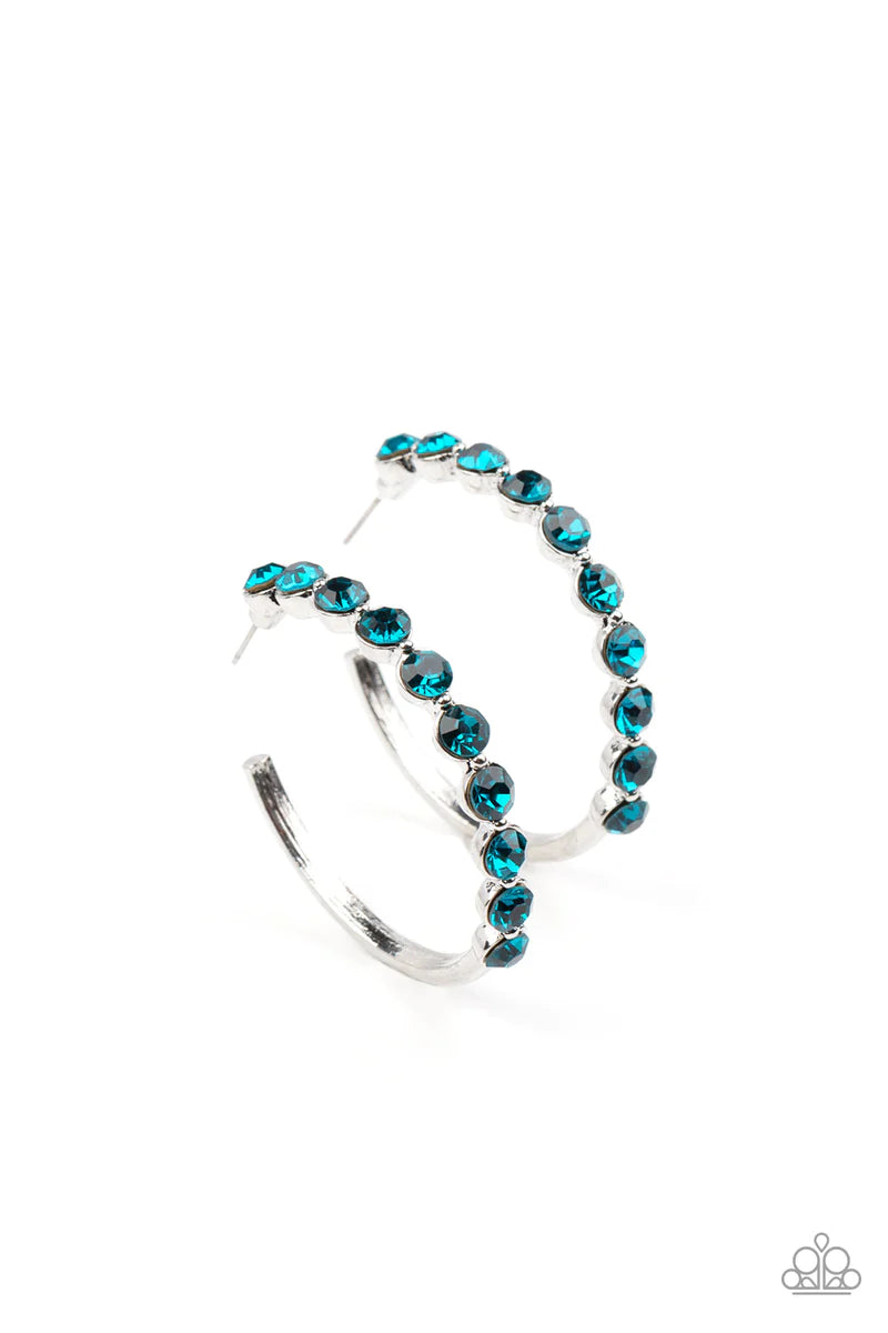 Paparazzi Accessories Photo Finish - Blue The front of a bold silver hoop is encrusted in glittery blue rhinestones, creating a glamorous pop of sparkle. Earring attaches to a standard post fitting. Hoop measures approximately 1 3/4" in diameter. Sold as