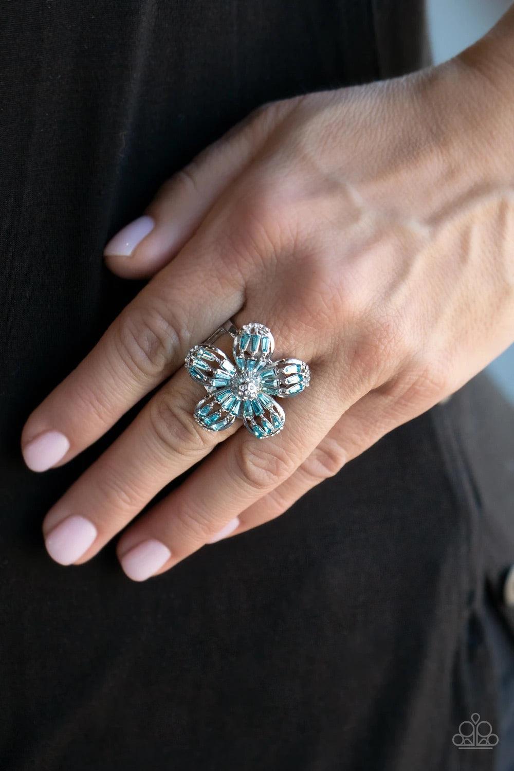 Paparazzi Accessories Botanical Ballroom - Blue Blue emerald-style rhinestones adorn the silver petals of a blooming flower featuring a white rhinestone encrusted beaded center. The tips of the colorful petals are dusted in dainty white rhinestones, addin