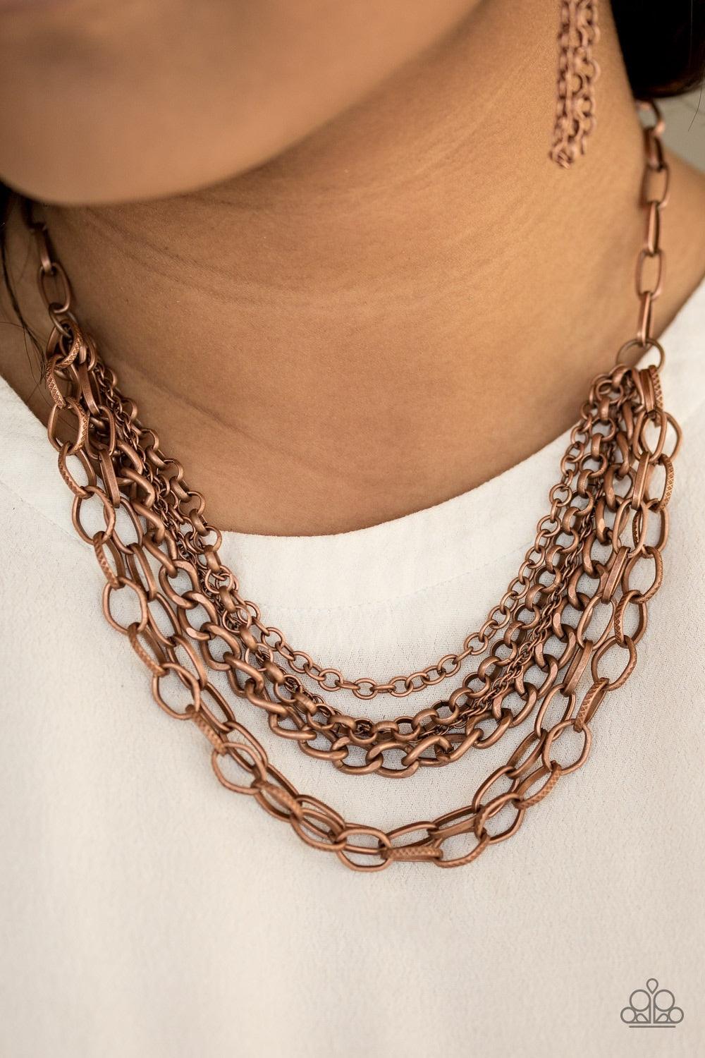 Paparazzi Accessories Word on the Street - Copper Varying in size and shape, glistening copper chains layer below the collar. Featuring smooth and textured links, the mixed metallic palette stacks into a collision of industrial shimmer for an edgy look. F