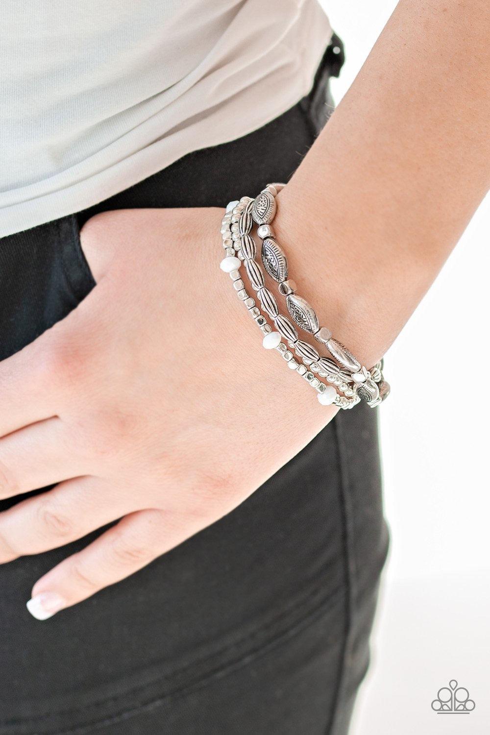 Paparazzi Accessories Full of Wander - White Infused with faceted white beads, a collection of mismatched silver beads are threaded along stretchy bands, creating colorful layers across the wrist. Jewelry