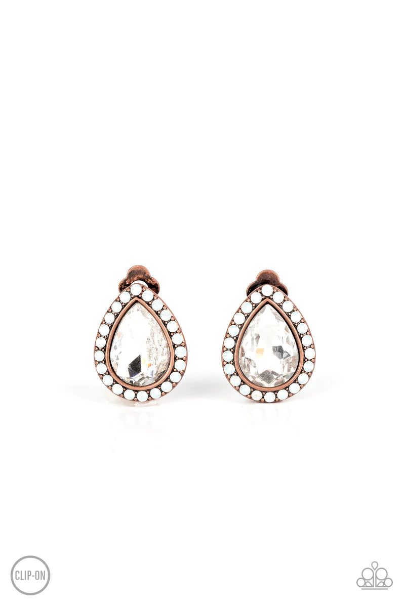 Paparazzi Accessories Cosmic Castles - Copper *Clip-On A faceted white teardrop gem is pressed into a copper frame bordered with opalescent white rhinestones for a glamorous finish. Earring attaches to a standard clip-on fitting. Sold as one pair of clip-