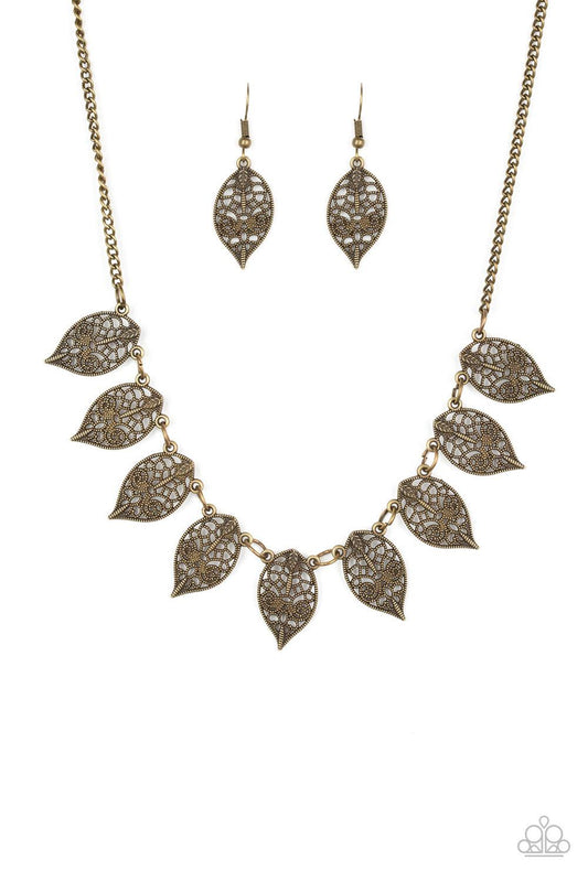 Paparazzi Accessories Leafy Lagoon - Brass Swirling with dotted filigree, dainty brass leaf frames swing from the bottom of a glistening brass chain, creating a whimsical fringe below the collar. Features an adjustable clasp closure. Sold as one individua