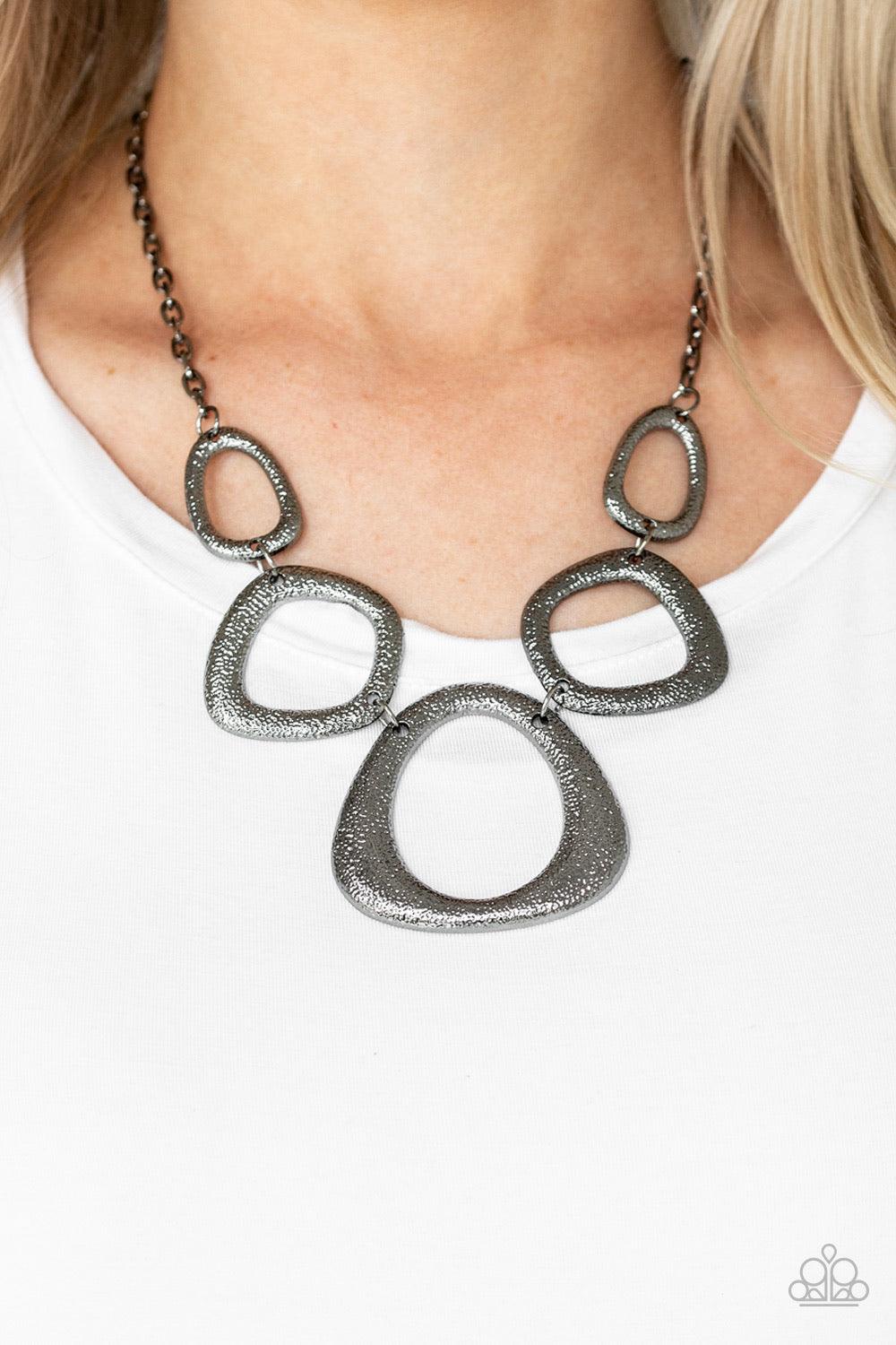 Paparazzi Accessories Backstreet Bandit - Black Hammered in a high-sheen finish, asymmetrical gunmetal frames link below the collar in an edgy statement-making fashion. Features an adjustable clasp closure. Sold as one individual necklace. Includes one pa