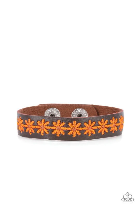 Paparazzi Accessories Wildflower Wayfarer - Orange Featuring dainty brown centers, a refreshing row of orange flowers is stitched across the front of a skinny brown leather band for a seasonal look. Features an adjustable snap closure. Sold as one individ