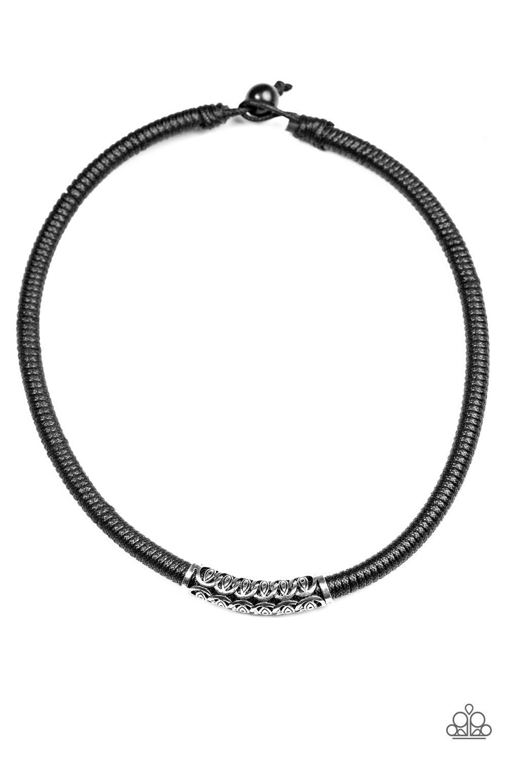 Paparazzi Accessories The Mainland - Black Black cording knots around a leather cord, creating a sleek urban piece below the collar. An ornate silver bead slides along the colorful strand, creating a bold centerpiece. Features a button loop closure. Jewel