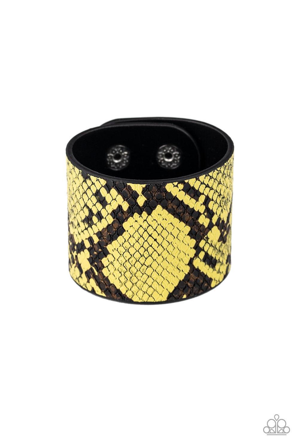 Paparazzi Accessories The Rest Is HISS-Tory - Yellow Featuring vibrant yellow and black python print, a thick black leather band wraps around the wrist for a wild fashion. Features an adjustable snap closure. Jewelry