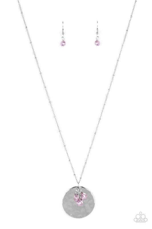 Paparazzi Accessories Seaside Shimmer - Purple A shimmering wavy silver disc sways from the bottom of a lengthened silver satellite chain. A cluster of light purple pearl beads dangles charmingly in front of the disc creating a tranquilly mystical pendant
