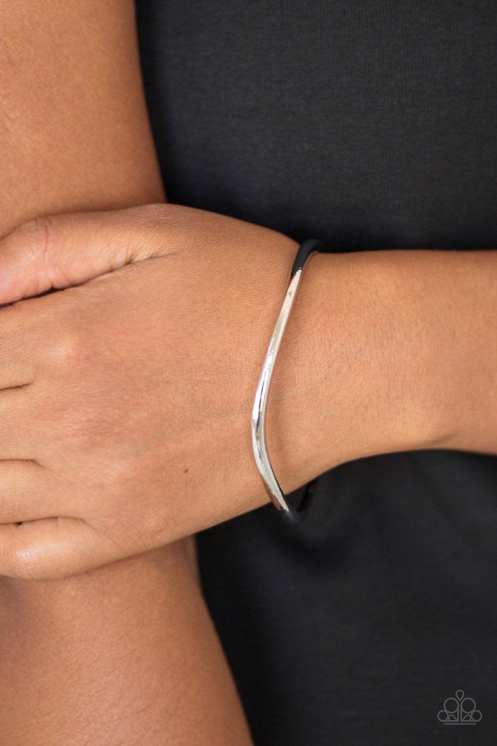 Paparazzi Accessories Awesomely Asymmetrical - Silver Featuring a warped surface, an asymmetrical shiny silver bangle slides along the wrist for an edgy look. Jewelry