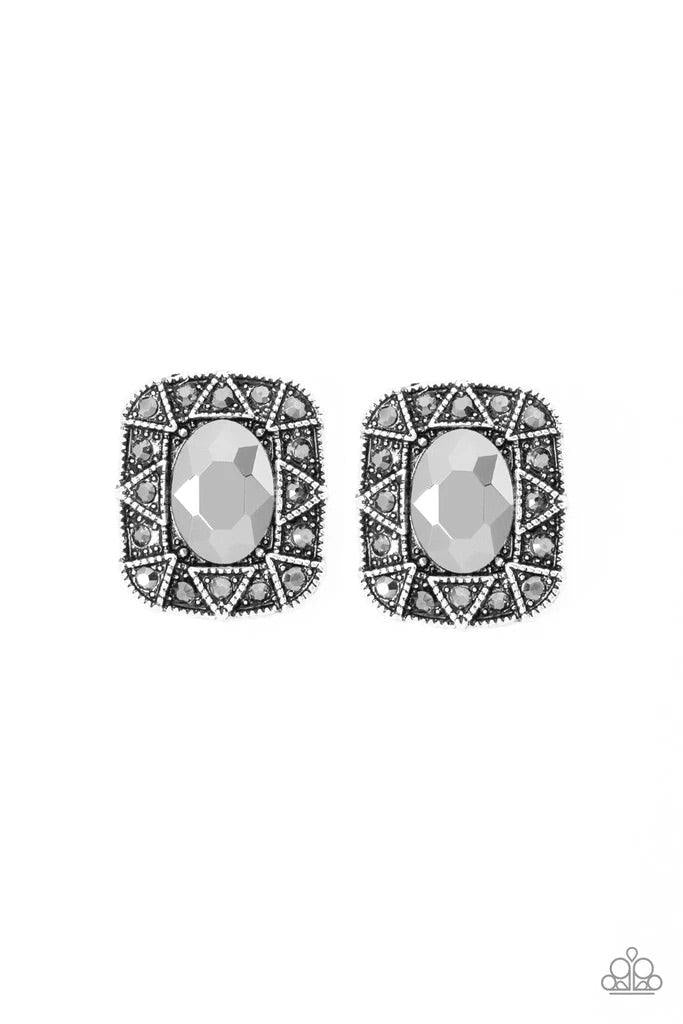 Paparazzi Accessories Young Money - Silver An oval hematite gem is pressed into a square silver frame radiating with glittery hematite rhinestones and triangular patterns for an edgy refinement. Earring attaches to a standard post fitting. Sold as one pai