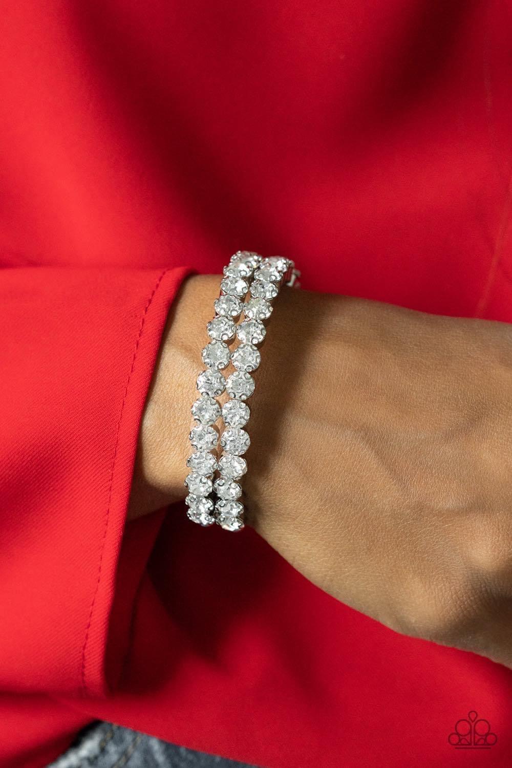 Paparazzi Accessories Megawatt Majesty - White Encased in sleek silver fittings, two oversized rows of glassy white rhinestones stack into a blinding cuff around the wrist for a jaw-dropping look. Sold as one individual bracelet. Jewelry