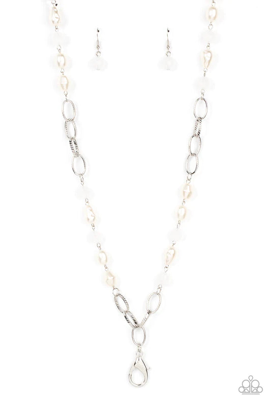 Paparazzi Accessories Tea Party Tango - White *Lanyard Featuring imperfect shapes, luscious pearly beads join opaque white faceted beads along sections of chunky silver chain across the chest for a glamorous look. Features an adjustable clasp closure. Sol