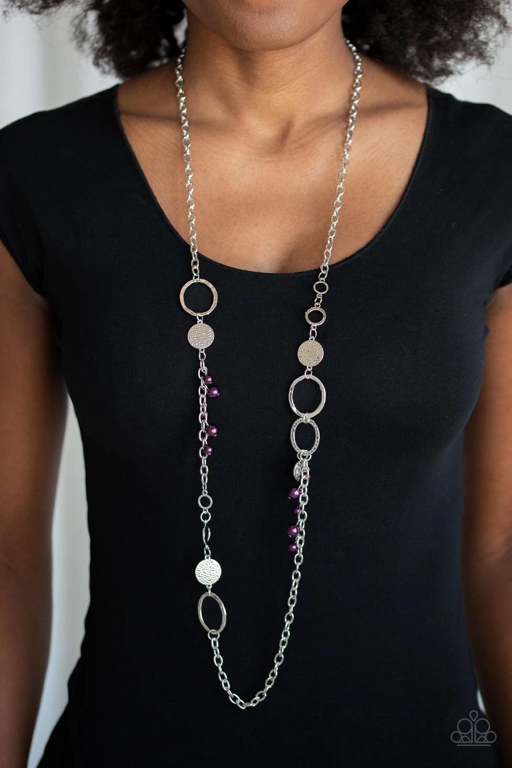 Paparazzi Accessories Unapologetic Flirt - Purple Infused with sections of shimmery silver chains, an assortment of hammered silver discs and silver rings link across the chest. A collection of pearly purple beads and dainty silver heart charms asymmetric