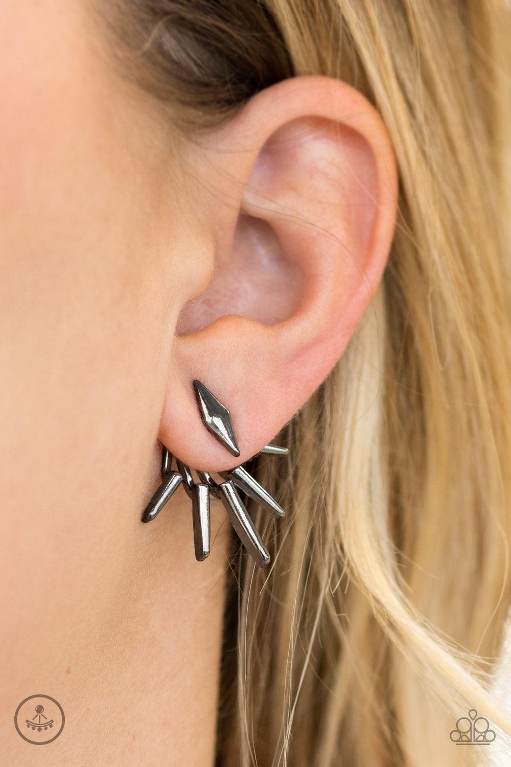 Paparazzi Accessories Extra Electric - Black A gunmetal diamond-shape frame attaches to a double-sided post, designed to fasten behind the ear. Radiating with matching gunmetal frames, the double-sided post peeks out beneath the ear, creating an edgy frin