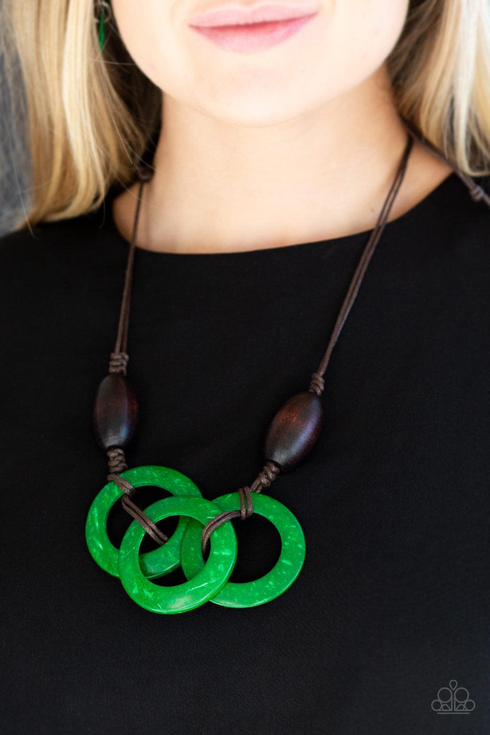 Paparazzi Accessories Bahama Drama - Green Infused with dramatic brown wooden beads, vivacious green wooden hoops are knotted in place below the collar for a summery flair. Features an adjustable sliding knot closure. Jewelry