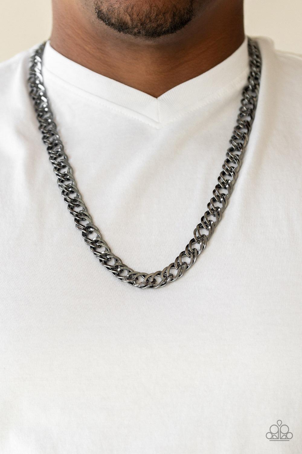 Paparazzi Accessories Undefeated - Black Featuring doubled links, a glistening gunmetal chain drapes across the chest for a bold look. Features an adjustable clasp closure. Sold as one individual necklace. Jewelry