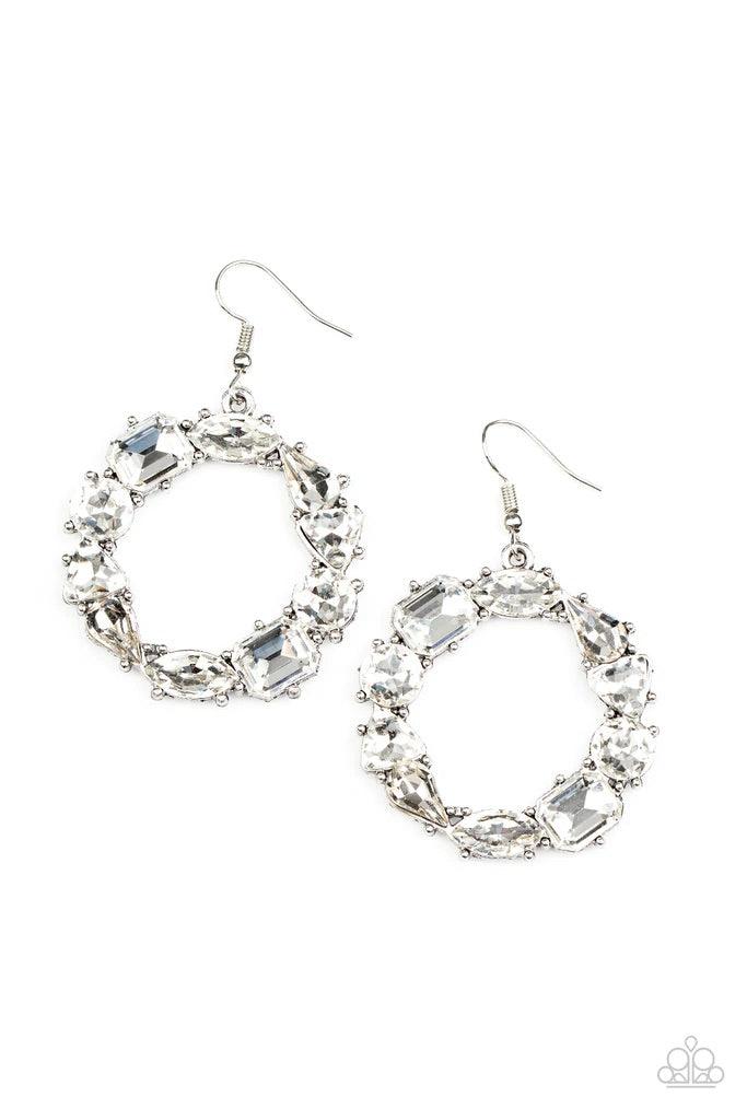Paparazzi Accessories GLOWING In Circles - White Featuring glistening silver fittings, a regal assortment of round, triangular, teardrop, marquise, and emerald cut white rhinestones delicately coalesce into a jaw-dropping hoop. Earring attaches to a stand