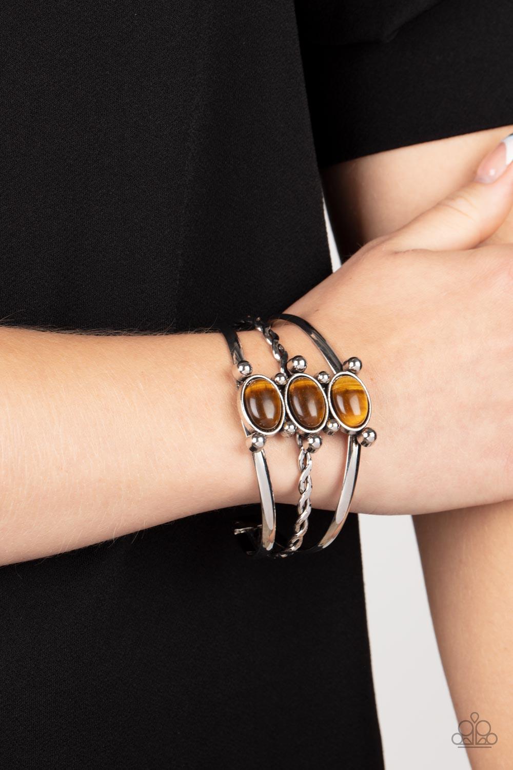 Paparazzi Accessories Extra Earthy - Brown Featuring silver studded fittings, an earthy trio of oval tiger's eye stones adorn the center of an ornately layered silver cuff for a seasonal finish. Sold as one individual bracelet. Jewelry