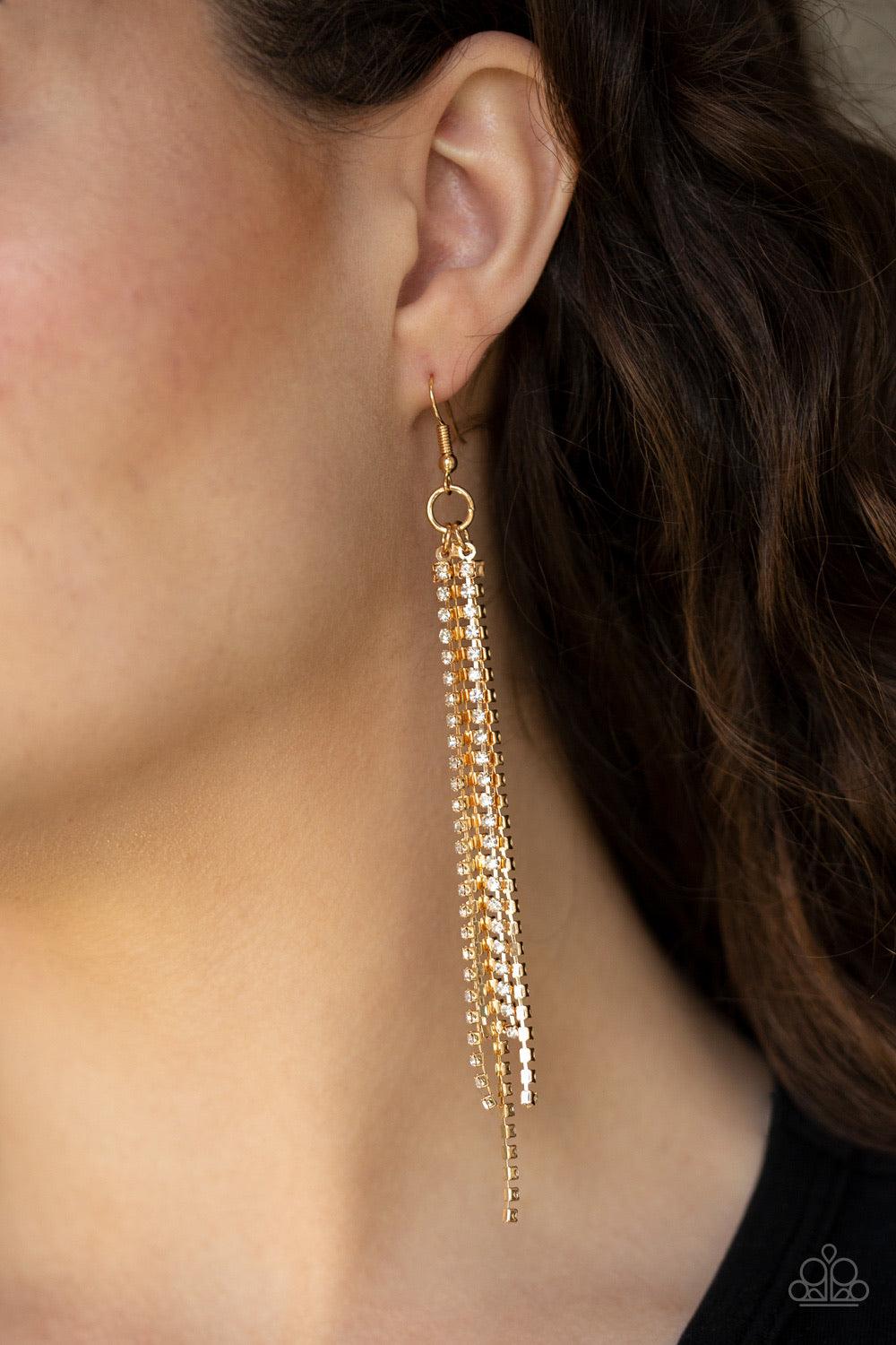 Paparazzi Accessories Center Stage Status - Gold Featuring sleek square fittings, strands of glittery white rhinestones freefall from the ear, creating a glamorous fringe. Earring attaches to a standard fishhook fitting. Jewelry