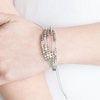 Paparazzi Accessories Modern Minimalism - White A collection of dainty silver beads and glistening silver cubes are threaded along strands of shiny gray cording around the wrist for a minimalist inspired look. Features an adjustable sliding knot closure.