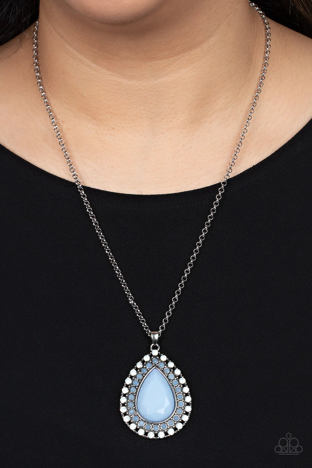 Paparazzi Accessories DROPLET Like It’s Hot - Blue A faceted blue teardrop is pressed into the center of a silver frame bordered in rows of opalescent white and blue beads, creating an ethereal pendant at the bottom of a classic silver chain. Features an