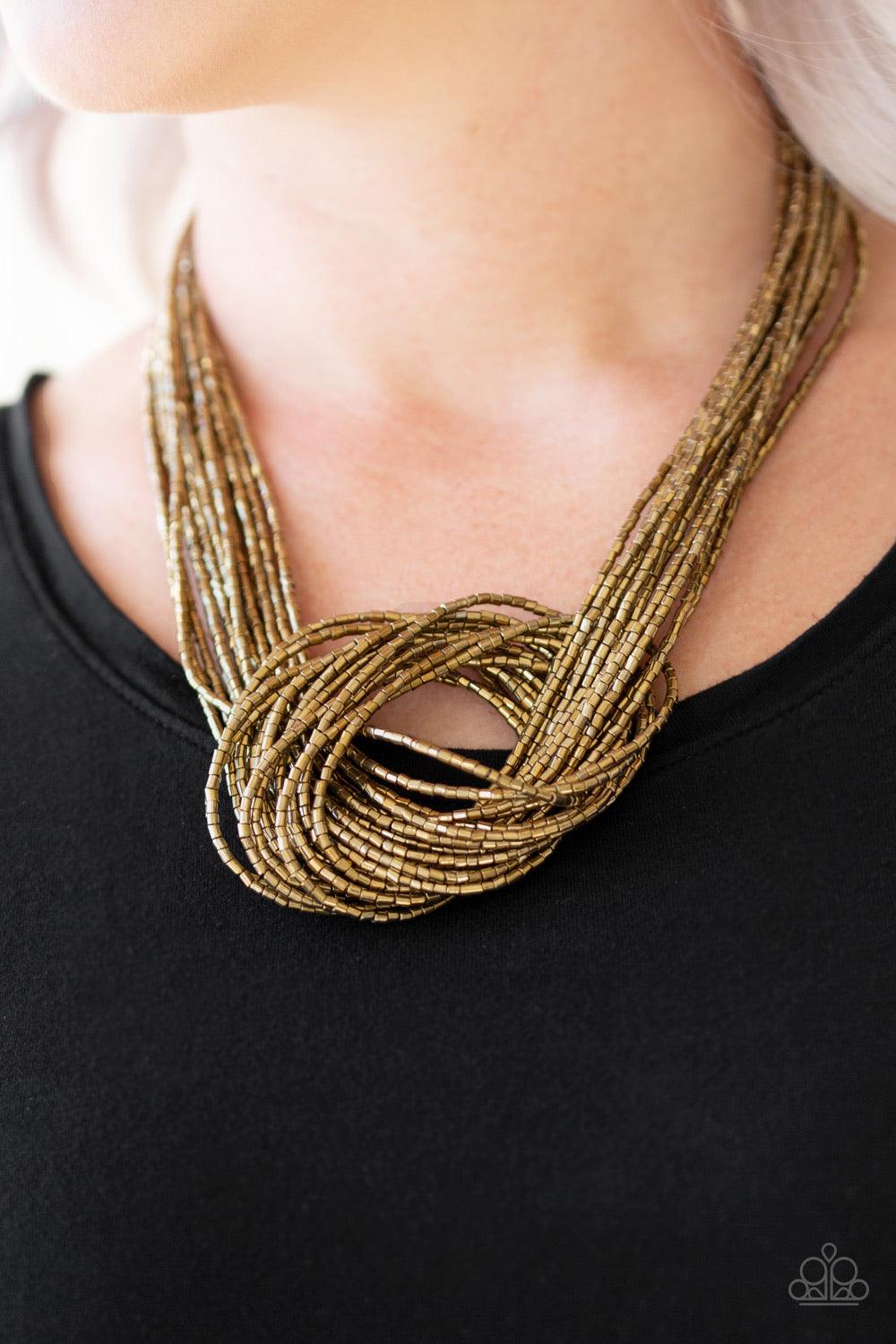 Paparazzi Accessories Knotted Knockout - Brass Countless strands of brass seed beads delicately knot together below the collar to create an unforgettable statement piece. Features an adjustable clasp closure. Sold as one individual necklace. Includes one