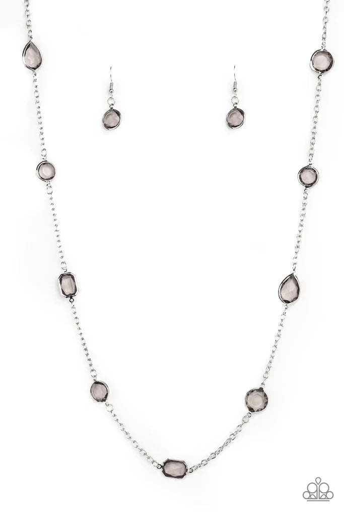 Paparazzi Accessories Glassy Glamorous - Silver Featuring sleek silver fittings, an array of glassy smoky gemstones trickle along a shimmery silver chain for a glamorous look. Features an adjustable clasp closure. Sold as one individual necklace. Includes