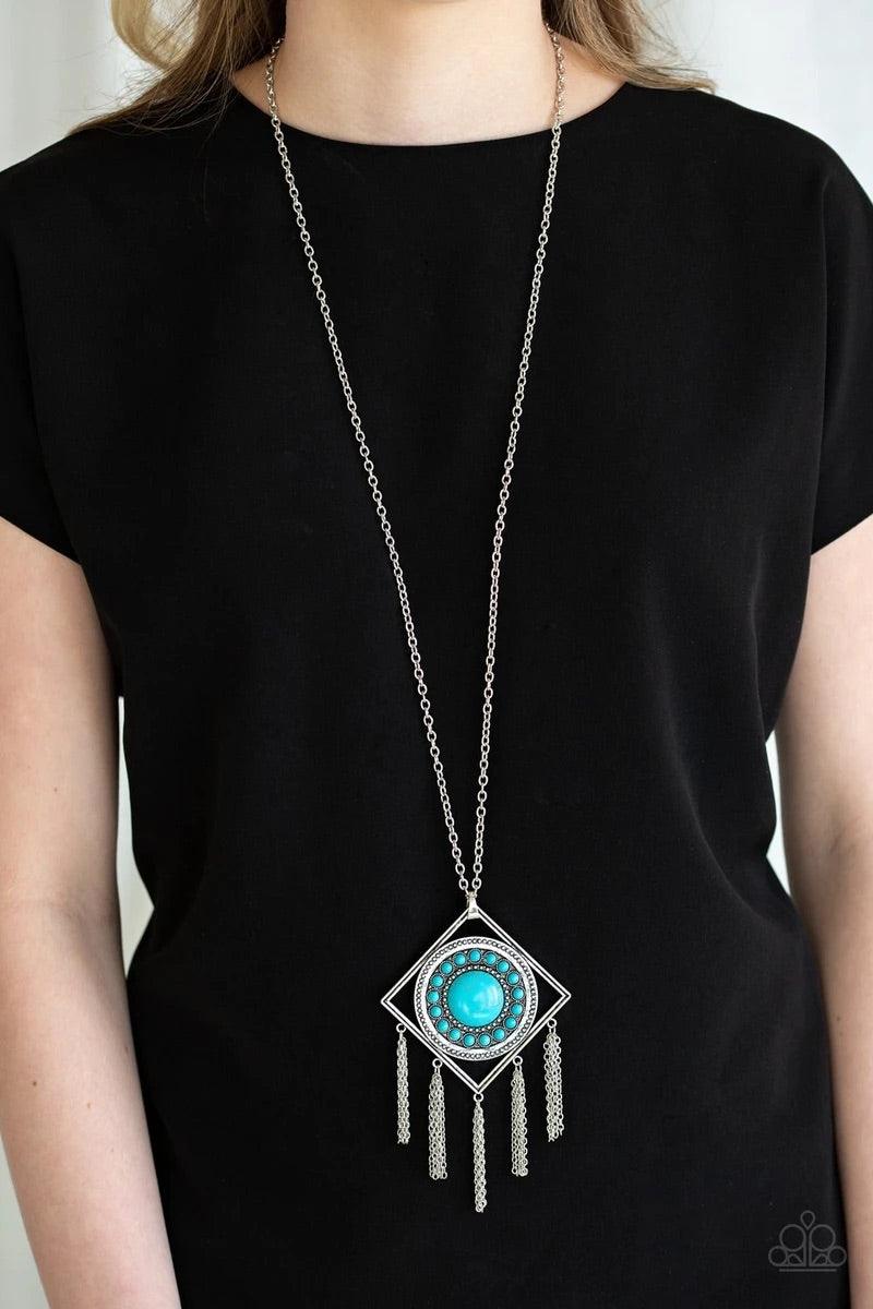 Paparazzi Accessories Sandstone Solstice - Blue Radiating with studded details and refreshing turquoise stones, a round frame is nestled inside of an airy silver square for a tribal inspired look. Attached to a lengthened silver chain, the colorful stone