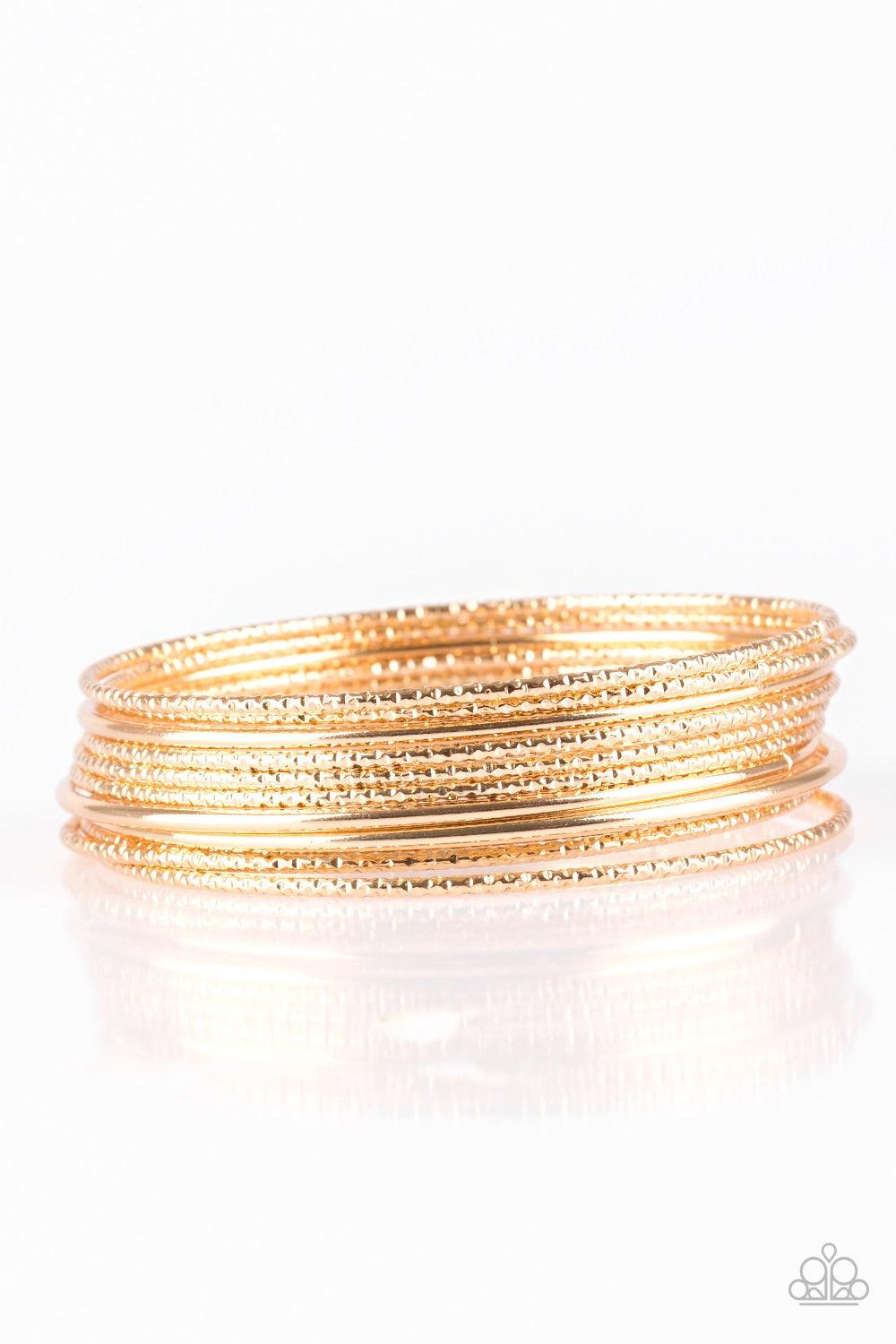 Paparazzi Accessories Bangle Babe - Gold Featuring smooth and shimmery diamond-cut textures, mismatched gold bangles stack across the wrist for a casual look. Jewelry