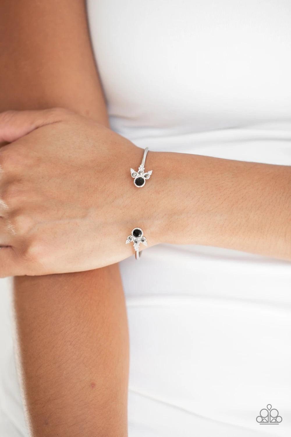 Paparazzi Accessories A Bit Rich - Black Featuring regal hematite and black rhinestone encrusted fittings, a dainty silver cuff curls around the wrist for a refined look. Sold as one individual bracelet. Bracelets